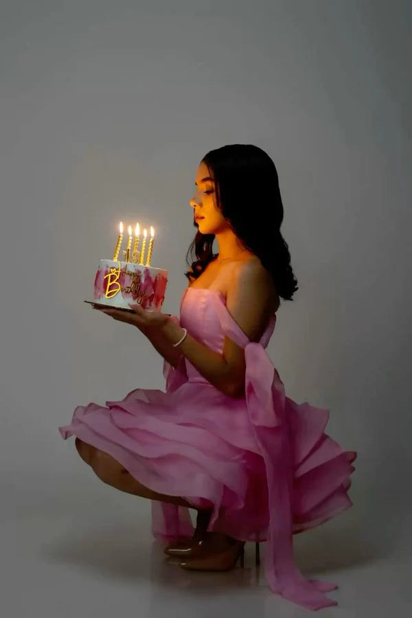 Pink chiffon off-shoulder mini ball gown, side view.