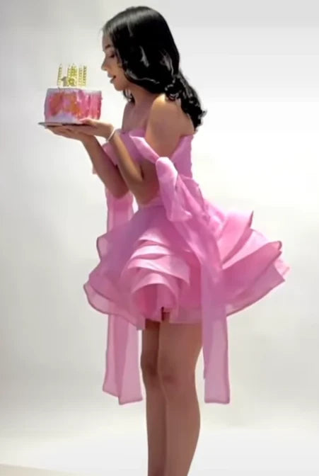 Back view of pink chiffon off-shoulder mini ball gown.