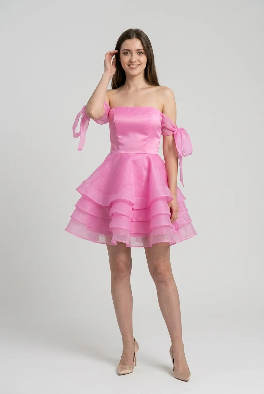 Model wearing pink chiffon off-shoulder mini ball gown.