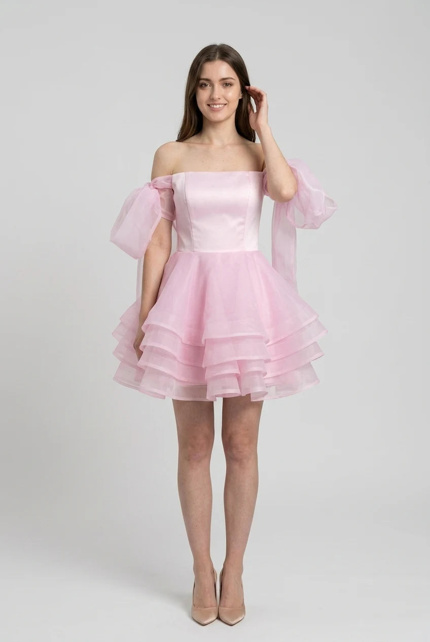 Full length view of pink chiffon off-shoulder mini ball gown.