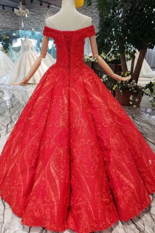 Close-up of lace appliques and beads on an off-shoulder prom dress.