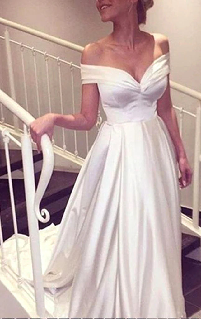 Woman wearing an elegant off-shoulder long satin prom dress.