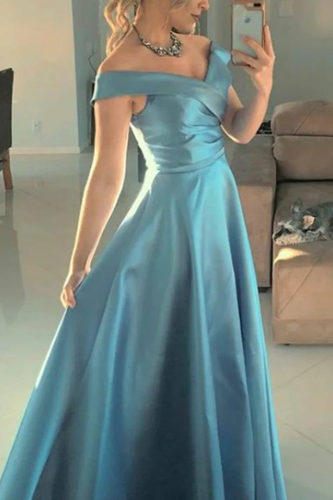Side profile of a woman in the flowing satin prom gown.