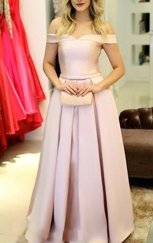 Woman wearing an elegant off-shoulder satin maxi prom dress.