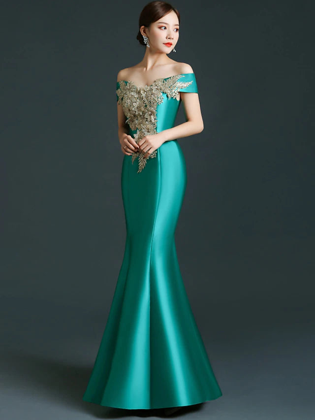 Back view of the floor-length satin mermaid gown, showcasing delicate appliques.