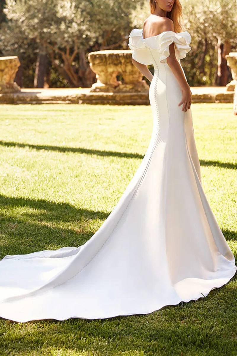 Back view of an off-shoulder satin mermaid wedding dress, showcasing the court train and elegant silhouette.