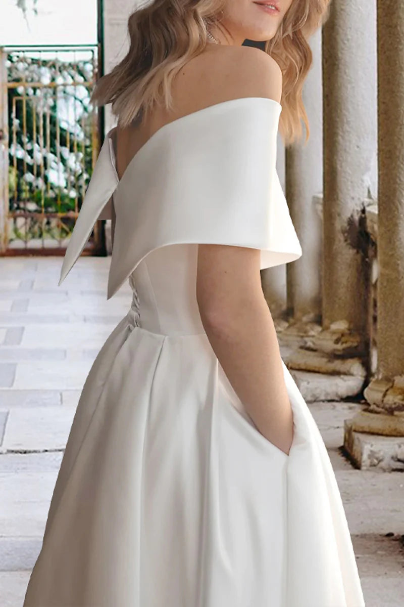Back view of the off-shoulder satin tea length wedding dress, showcasing the silhouette.