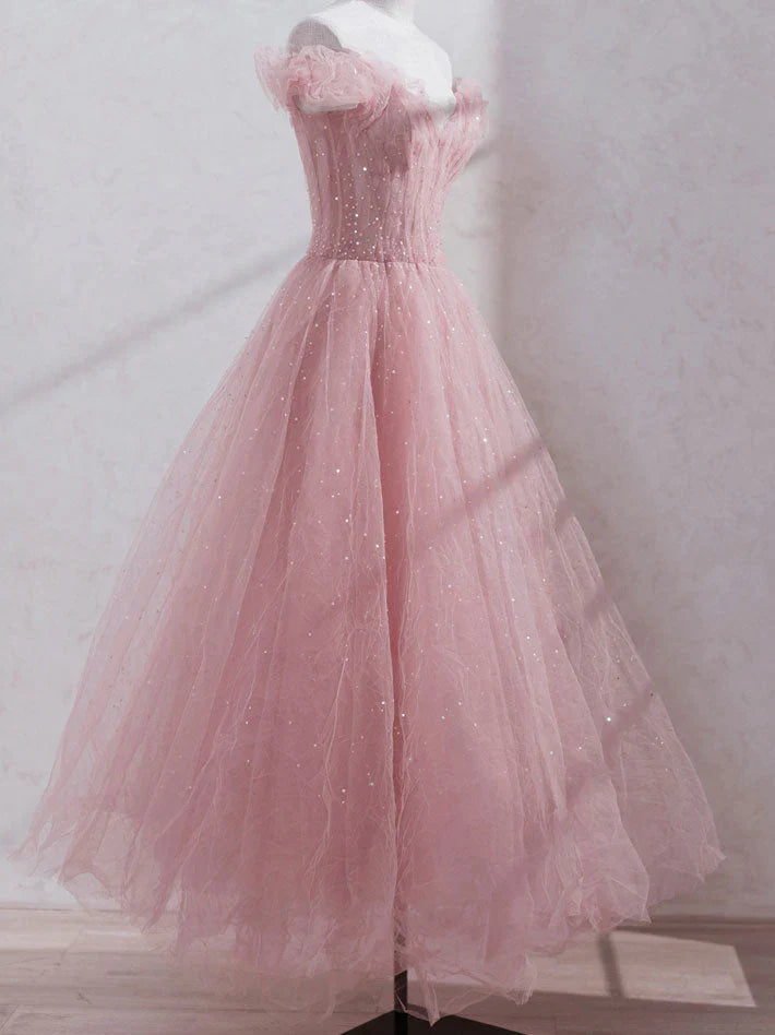Back view of a model in a shimmering off-shoulder sequin and tulle prom dress.