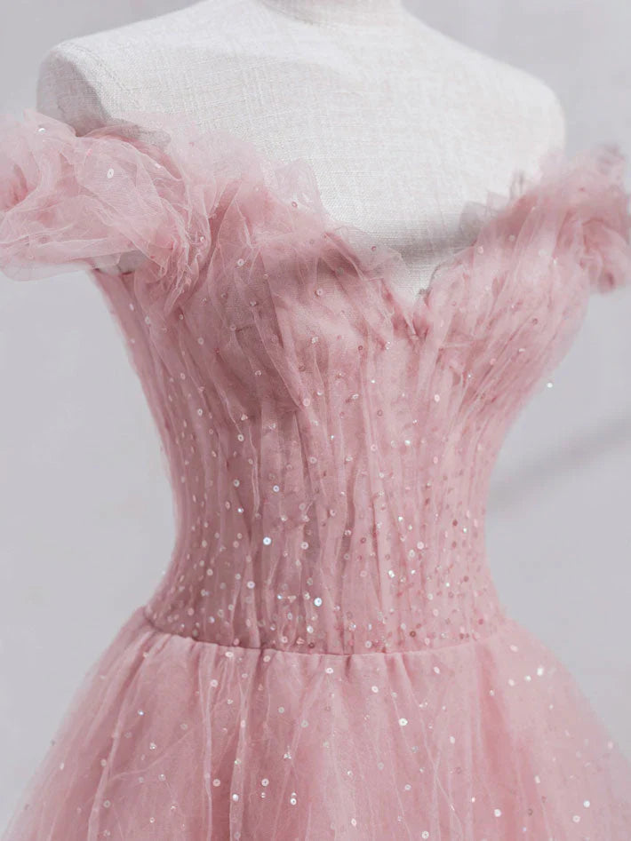 Close-up of the sequin and tulle fabric detail on the off-shoulder long dress.