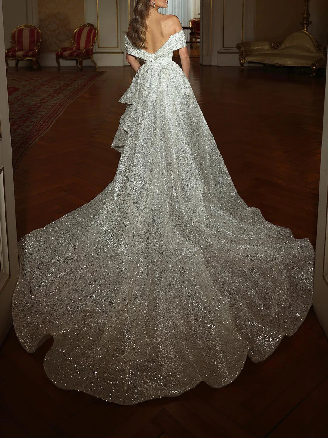 Off-shoulder formal sheath gown, side view.