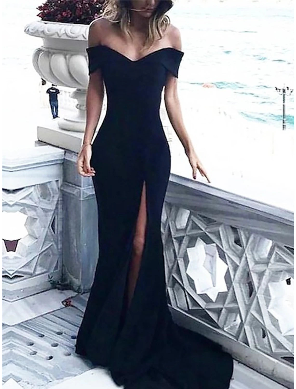 Close-up of the off-shoulder neckline and bodice of the elegant dress.