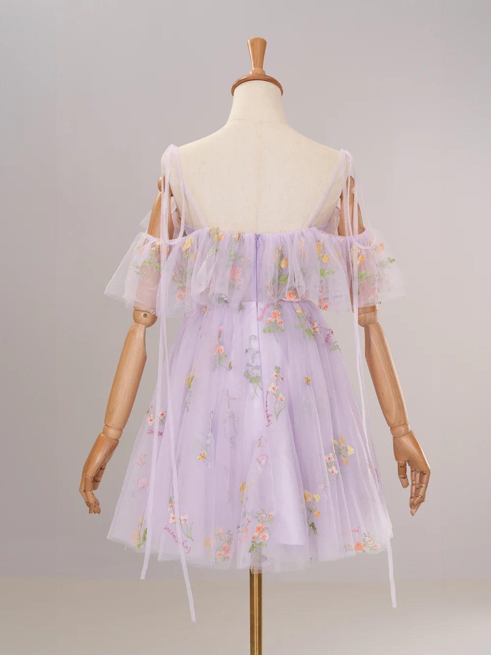 Back view of periwinkle off-shoulder homecoming dress with ruffled details.