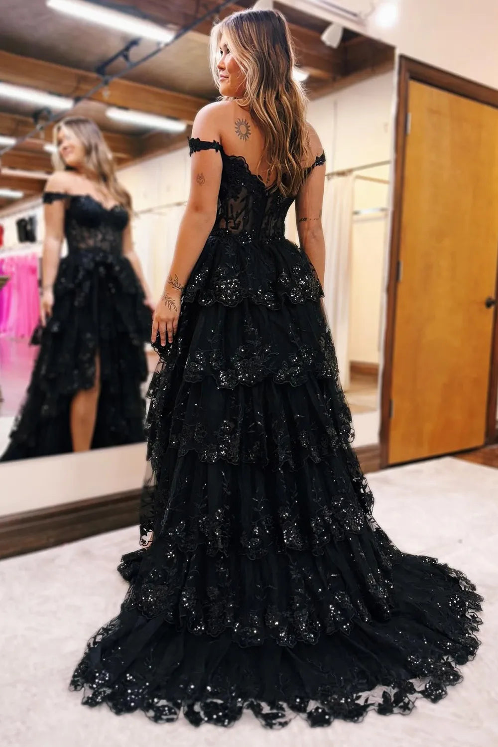 Flowing tiered skirt and applique details on the back of the gown.