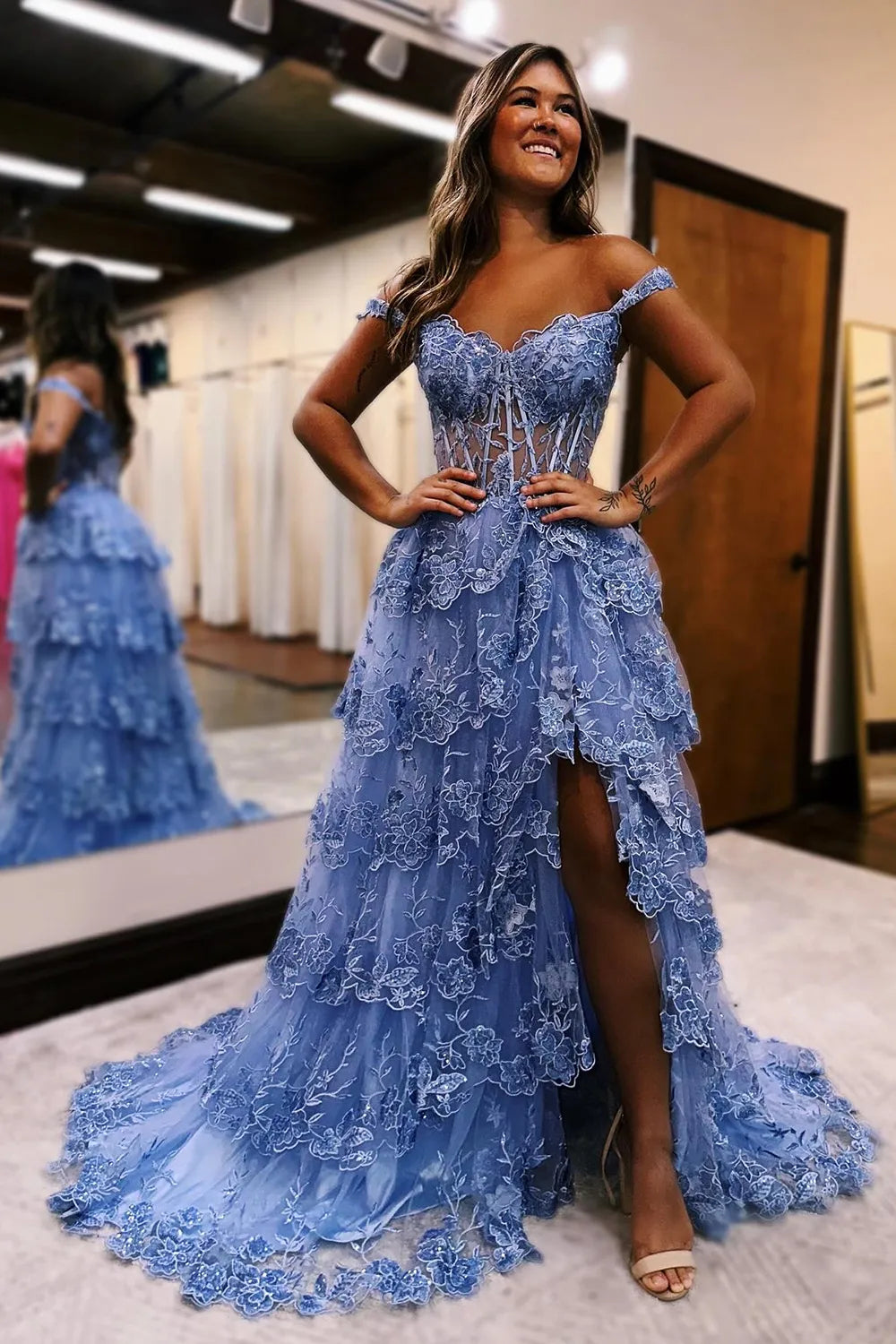 Blue off-shoulder tiered maxi prom dress.