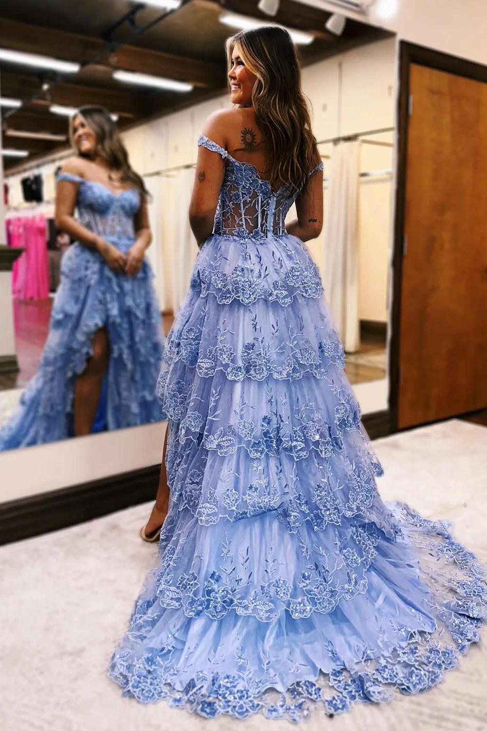 Side view of blue off-shoulder tiered prom dress.
