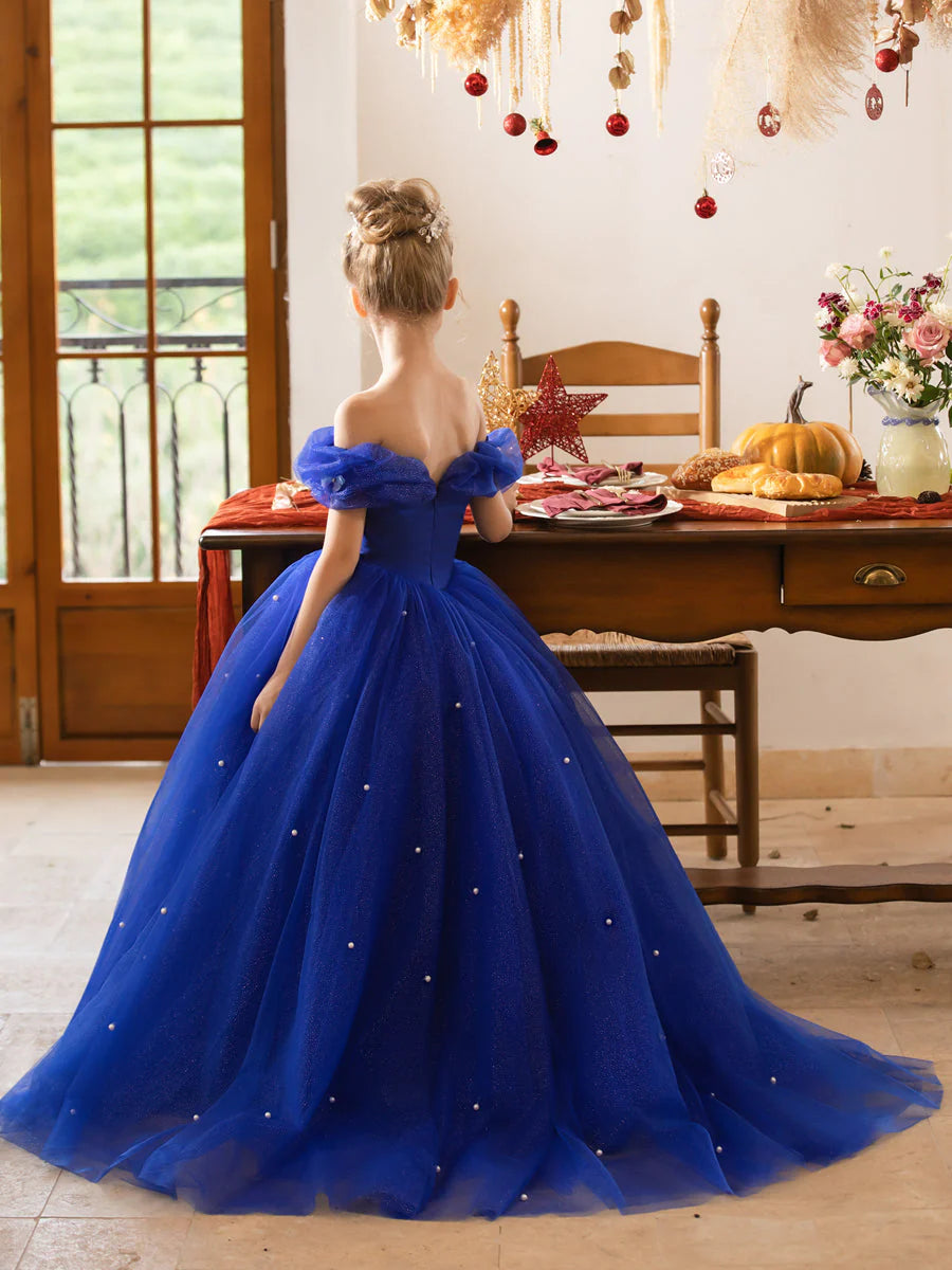 Close-up of the off-the-shoulder neckline and pearl details on a flower girl dress.