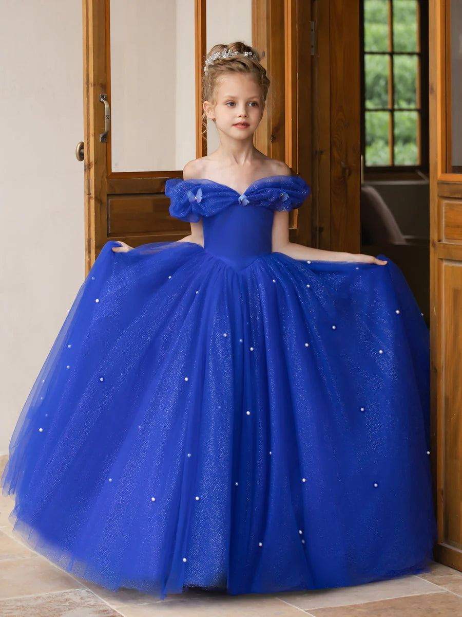 Side view of a flower girl dress, highlighting the flowy tulle and pearl accents.