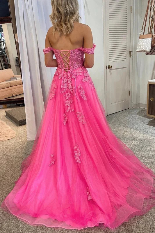 Side view of a model showcasing the high slit on an off-shoulder tulle lace prom gown.