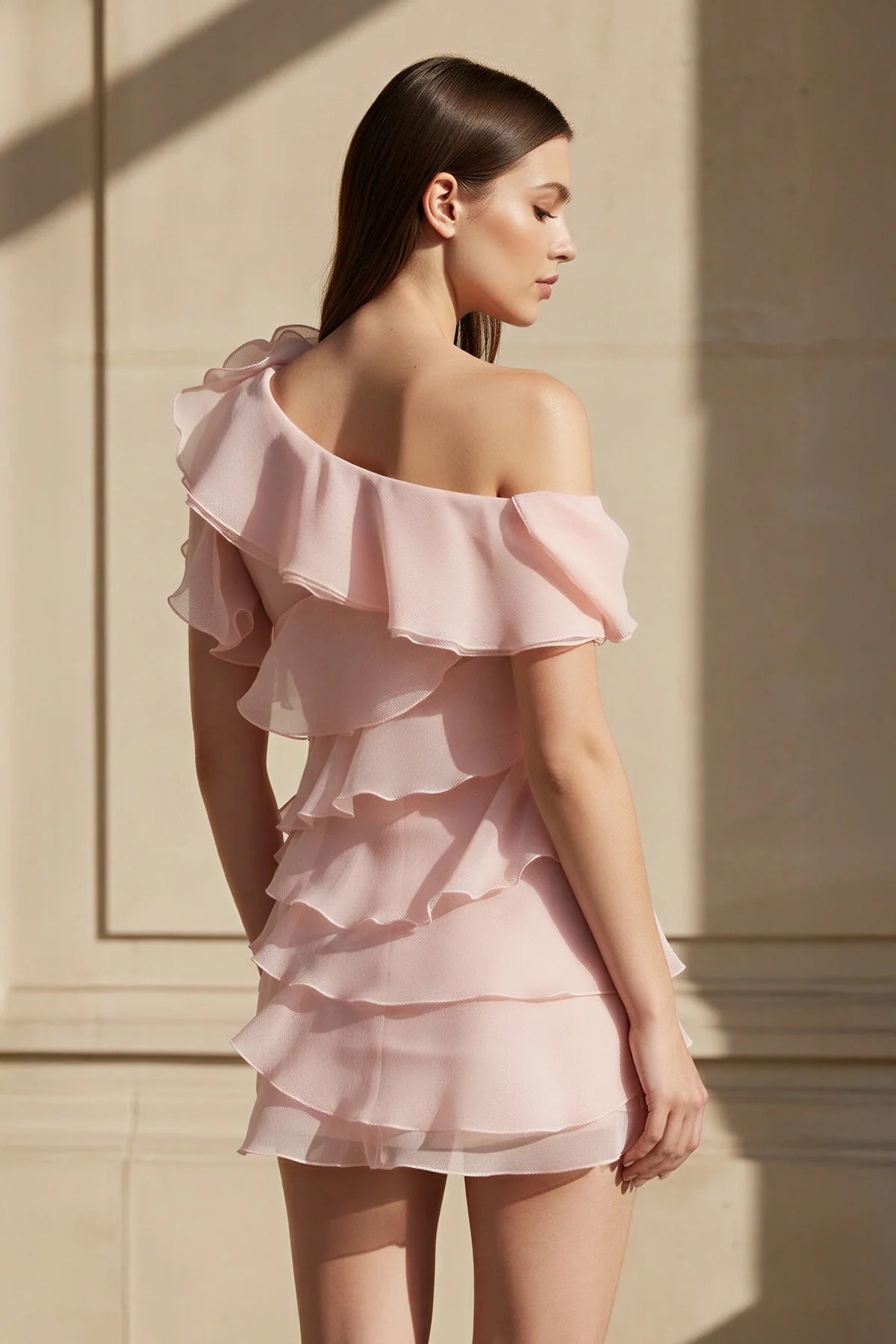 Model posing gracefully in the elegant one-shoulder mini homecoming dress.
