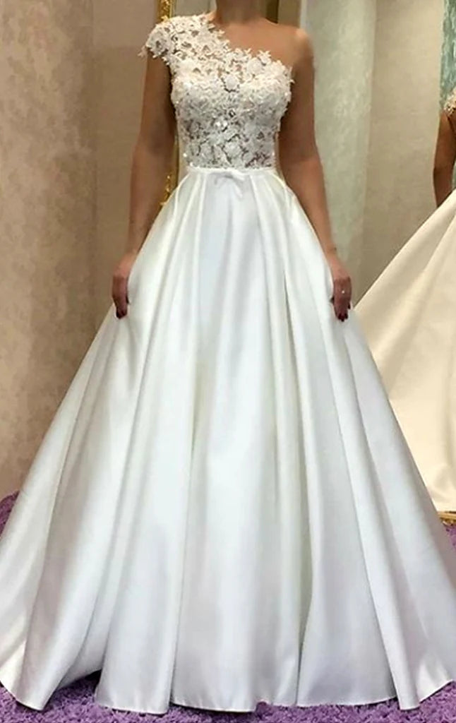 Woman wearing an elegant one-shoulder long A-line prom dress.