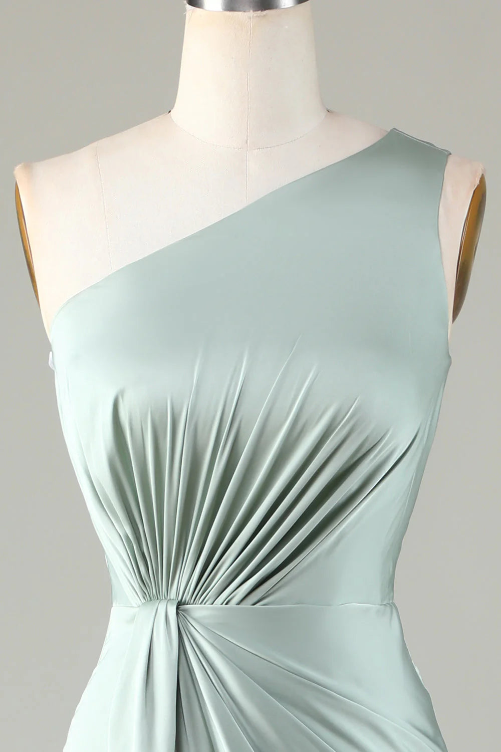 Close-up of a model in a one shoulder bridesmaid dress, highlighting the neckline detail.
