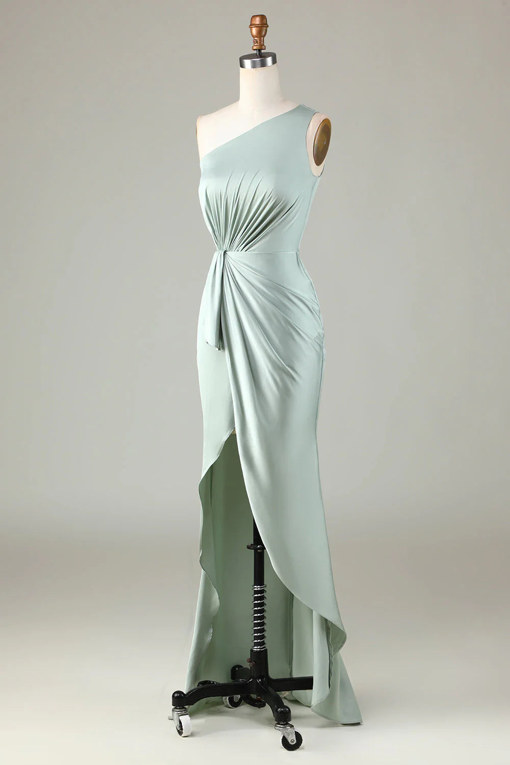Model in a one shoulder bridesmaid dress, standing with a confident posture.
