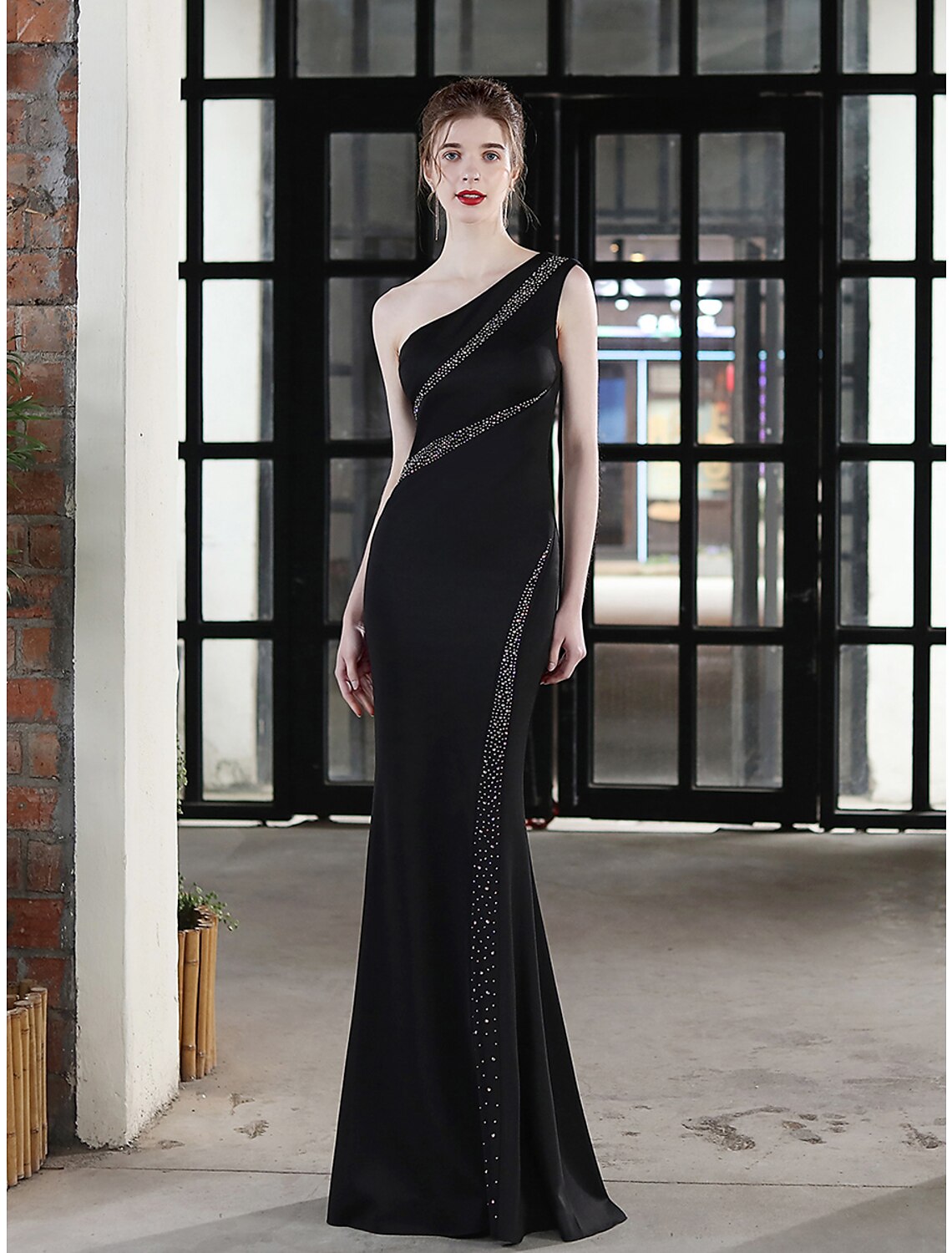 One-shoulder mermaid evening gown in stretch satin with crystal accents.
