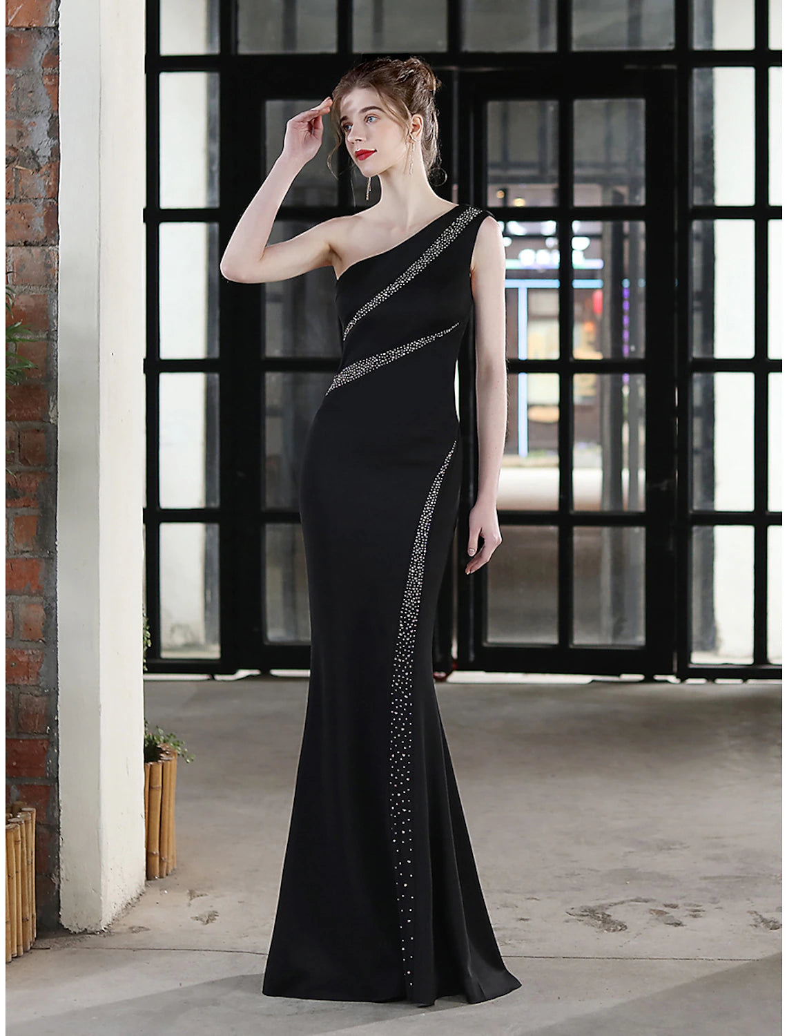 Side profile of the elegant one-shoulder mermaid dress.