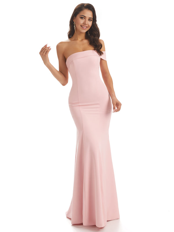 Woman wearing an elegant one-shoulder mermaid satin formal dress.