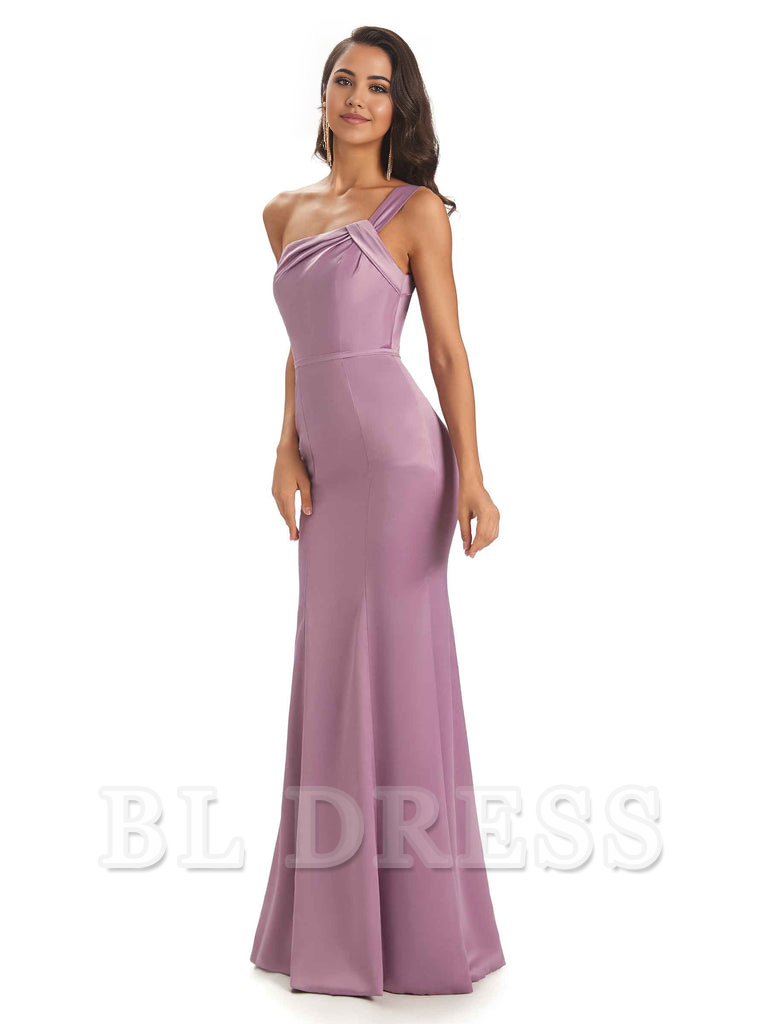 Side view of a woman posing in a teal one-shoulder formal satin dress.