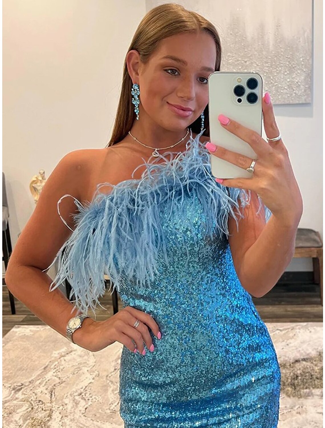 Back view of a sequined one-shoulder party dress.