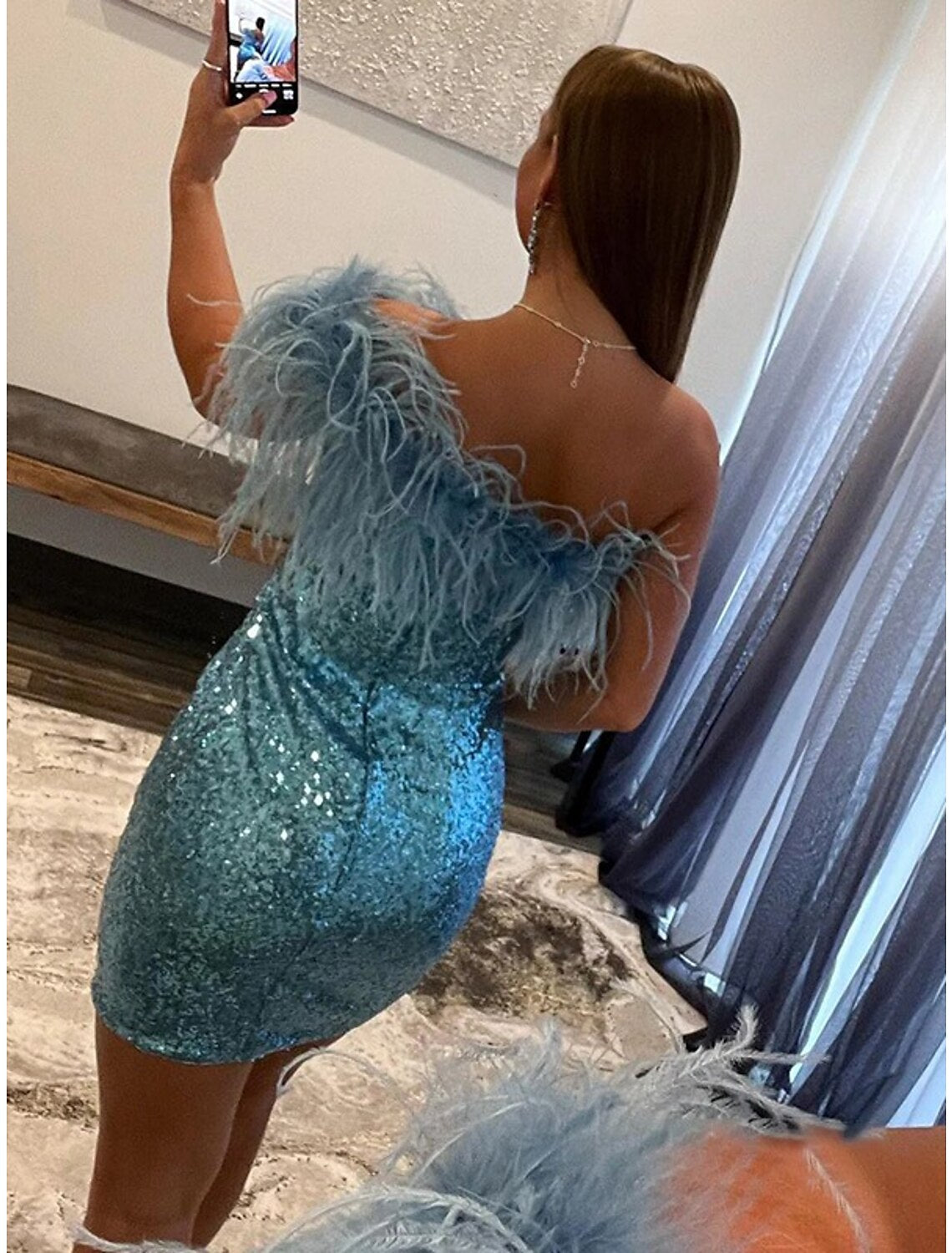 Side profile of a mermaid silhouette cocktail dress.