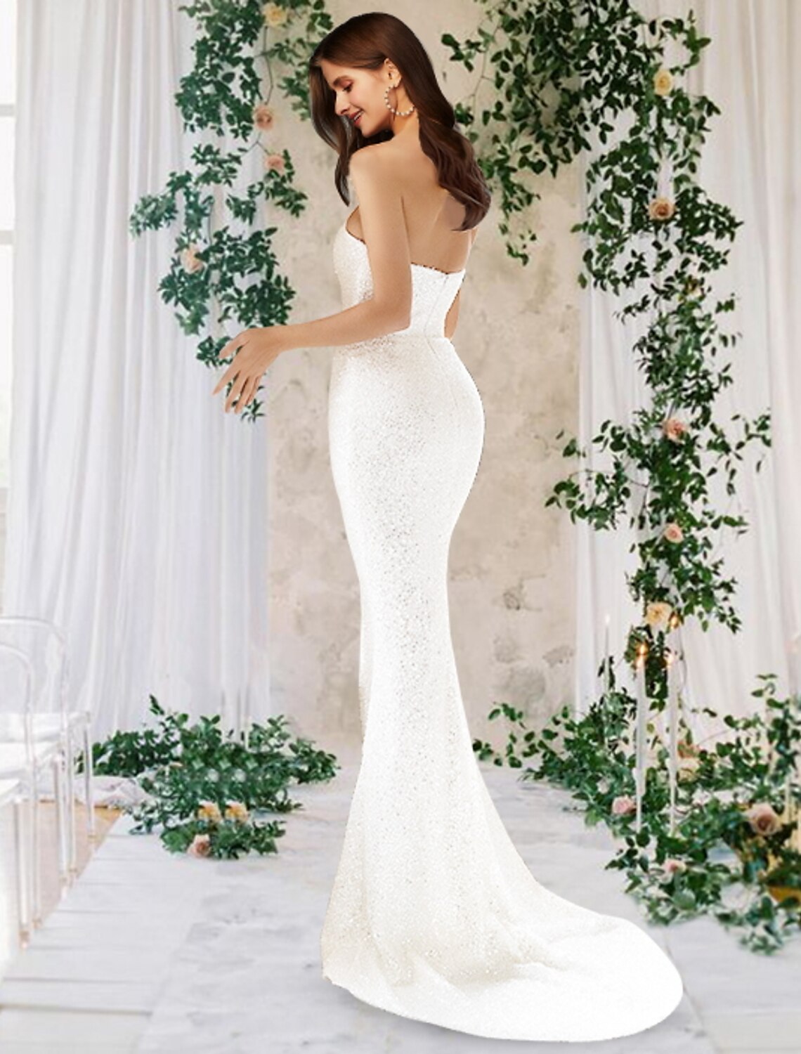 Back view of a sparkling one-shoulder satin bridal gown with a flowing court train.