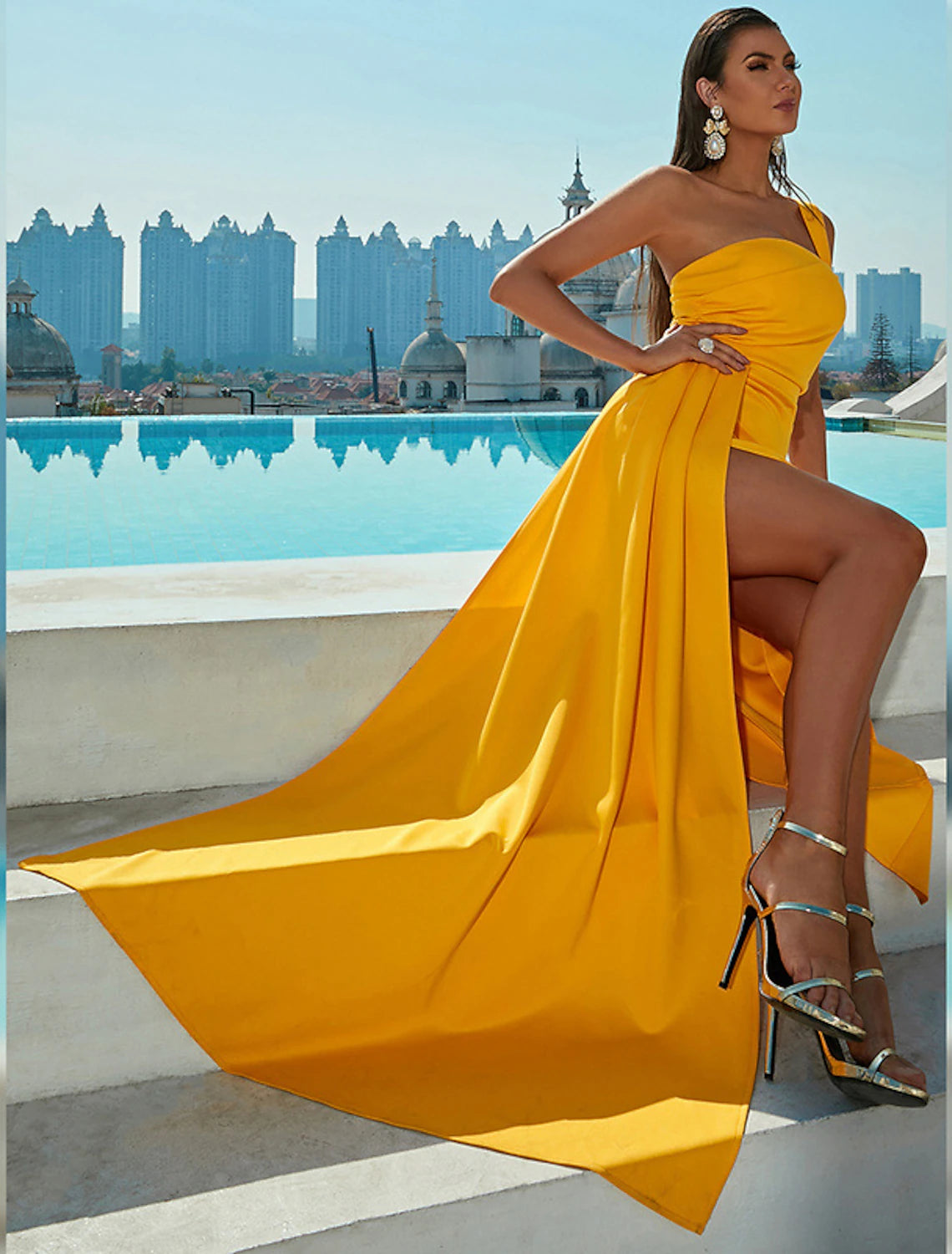 Close-up of the ruched slit and fabric detail on the dark blue mermaid trumpet gown.
