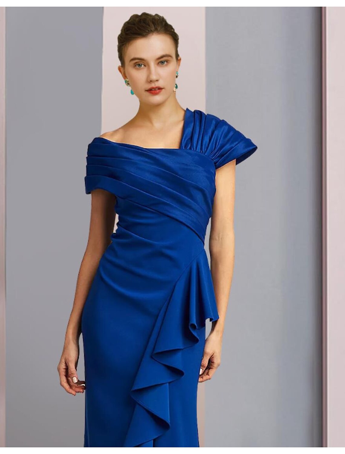 Close-up of the one-shoulder neckline and ruched ruffle details on the satin formal gown.