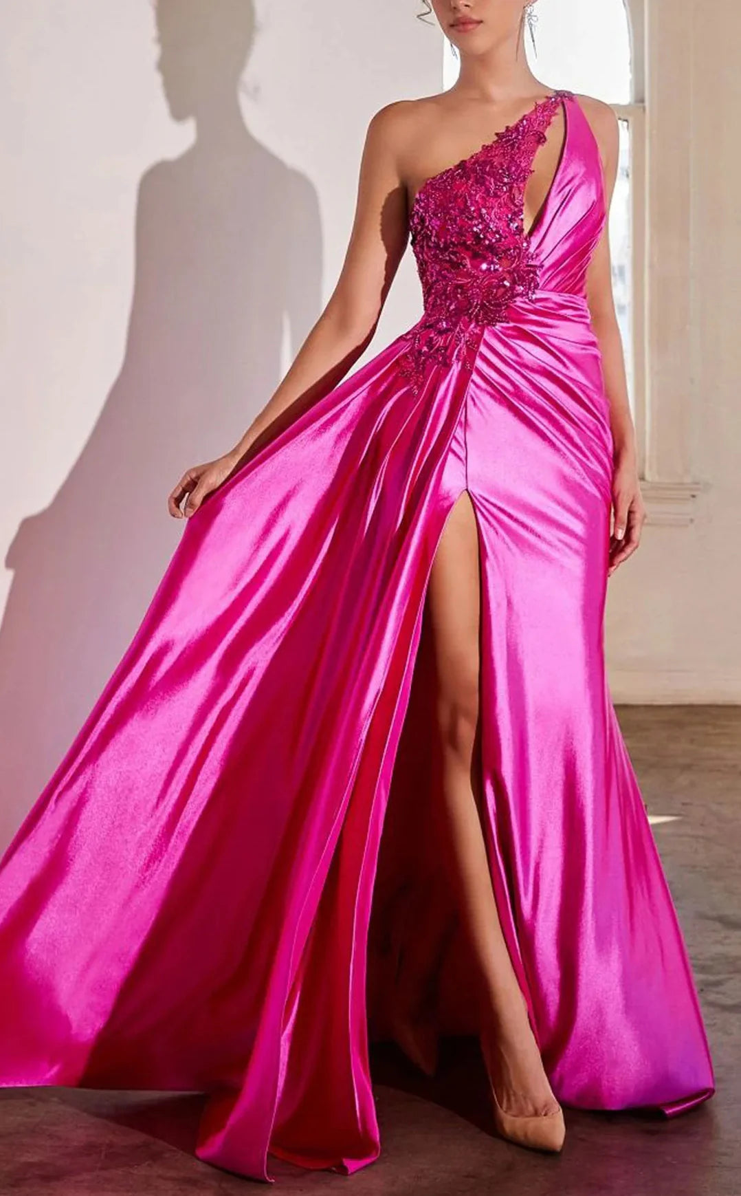 Back view of a model in a sleek one-shoulder formal gown.