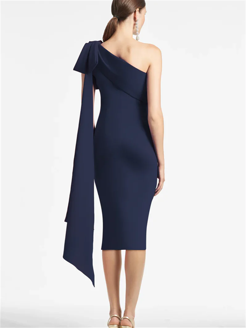 Close-up of the one-shoulder neckline and fitted bodice of the sheath dress.