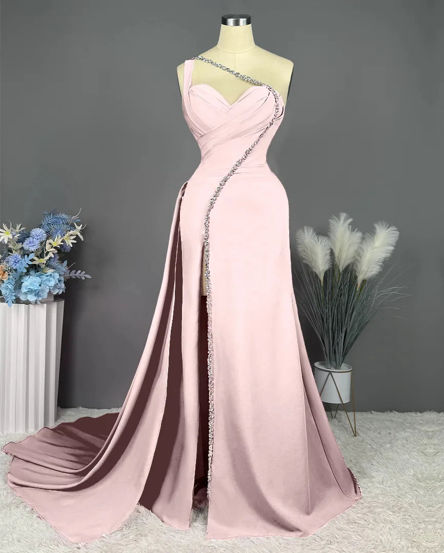 Elegant woman wearing a one-shoulder floor-length sheath prom dress.