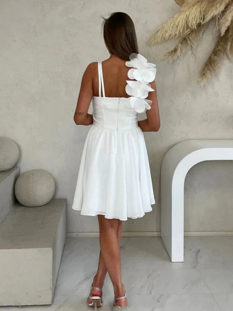 Close-up of 3D floral embellishments on a one-shoulder chiffon dress.
