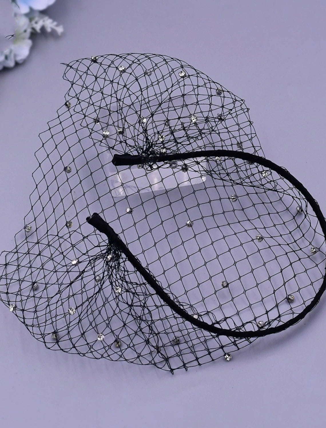 Elegant bridal accessory, a short wedding veil with sparkling accents.