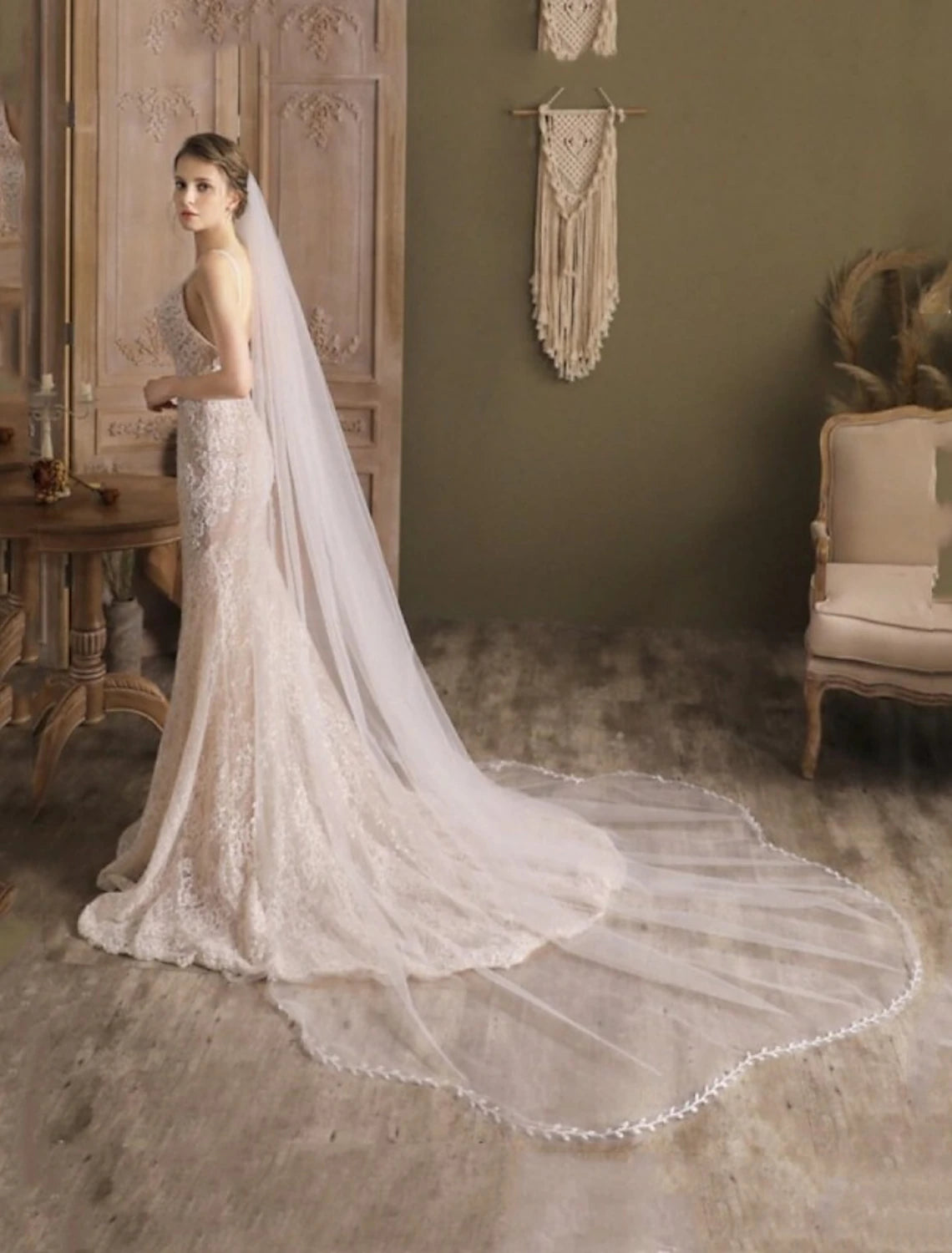 Bride wearing a classic cathedral veil with delicate faux pearls.
