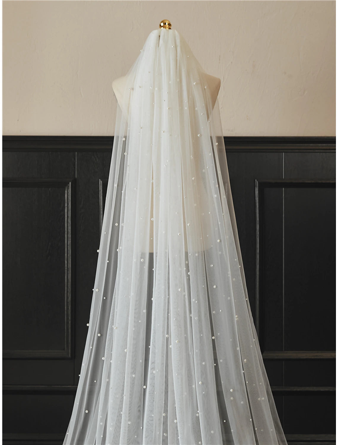 Close-up of the faux pearl embellishments on the tulle wedding veil.