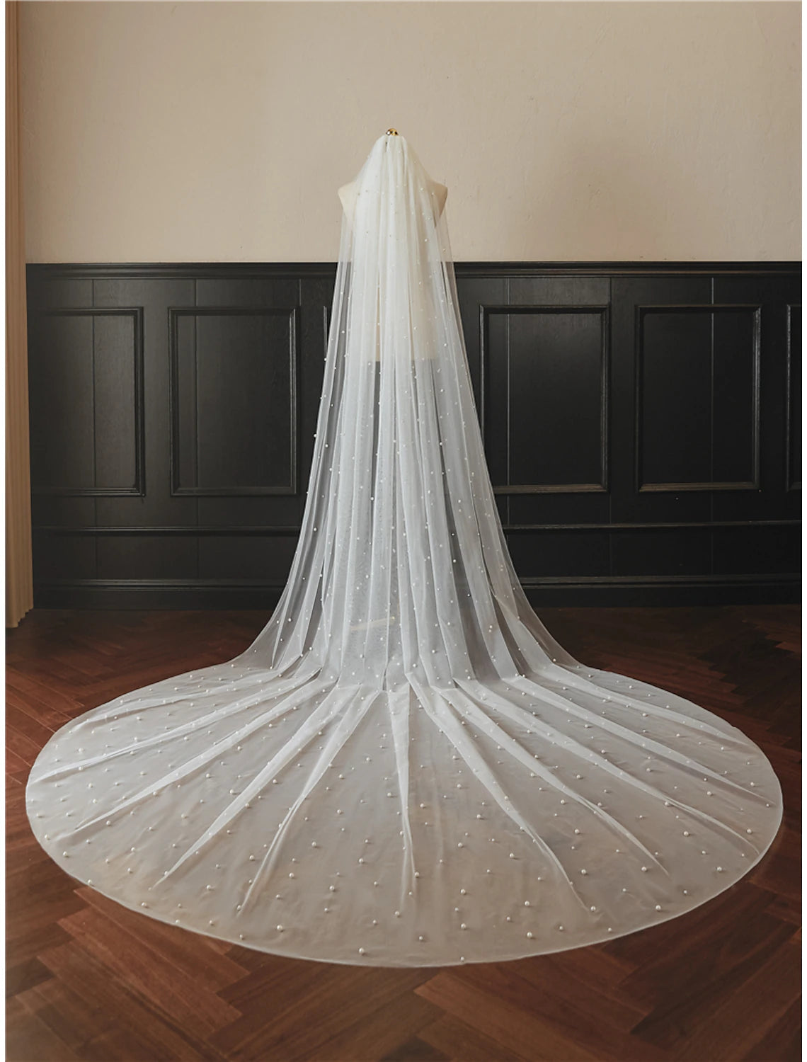 Detailed view of the delicate tulle fabric and faux pearls on the bridal veil.
