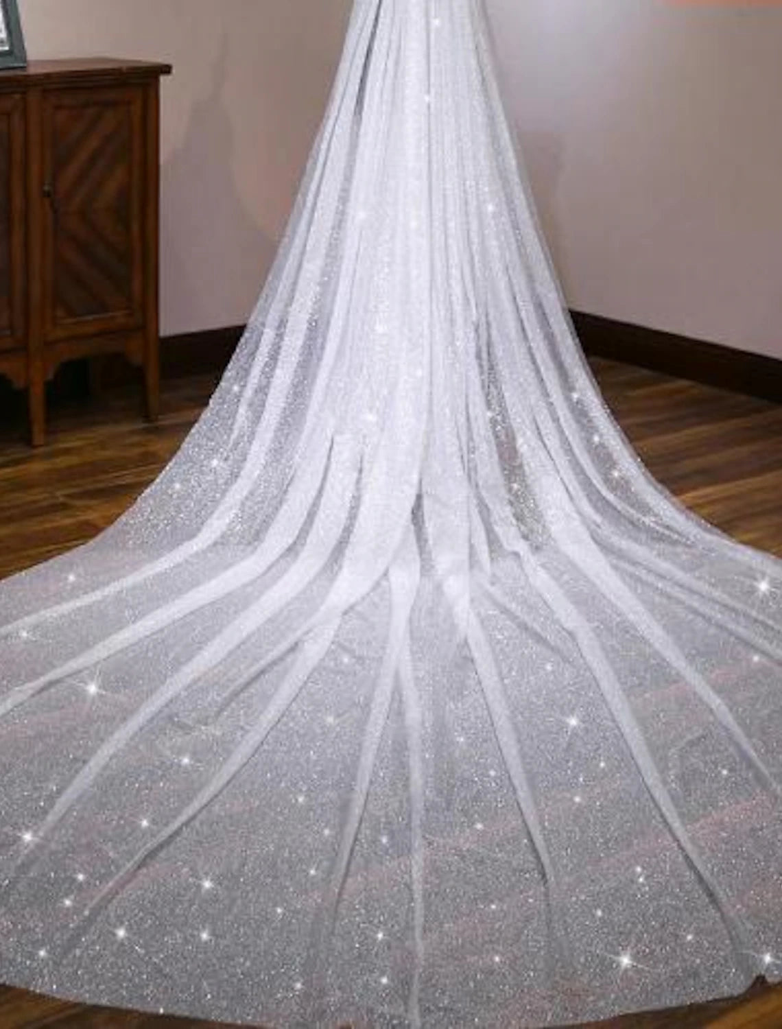 Bride walking, showcasing the full length of a one-tier cathedral wedding veil.