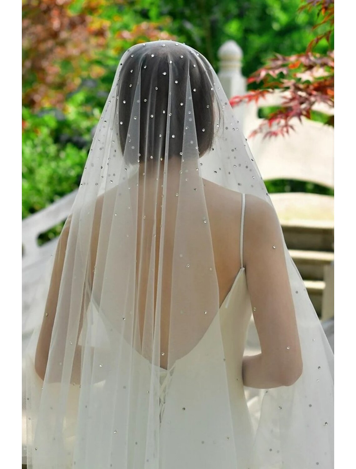 Rear view of a bride showcasing the flowing 160cm tulle chapel wedding veil with subtle sparkle.