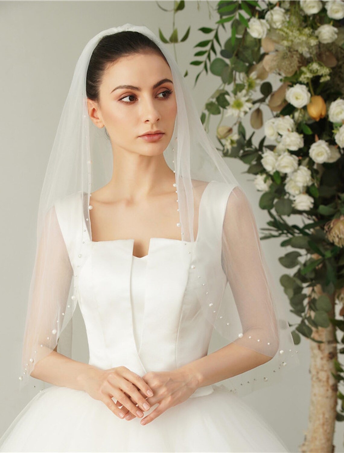 Bride wearing a 90cm one-tier elbow veil, showcasing its length and drape.
