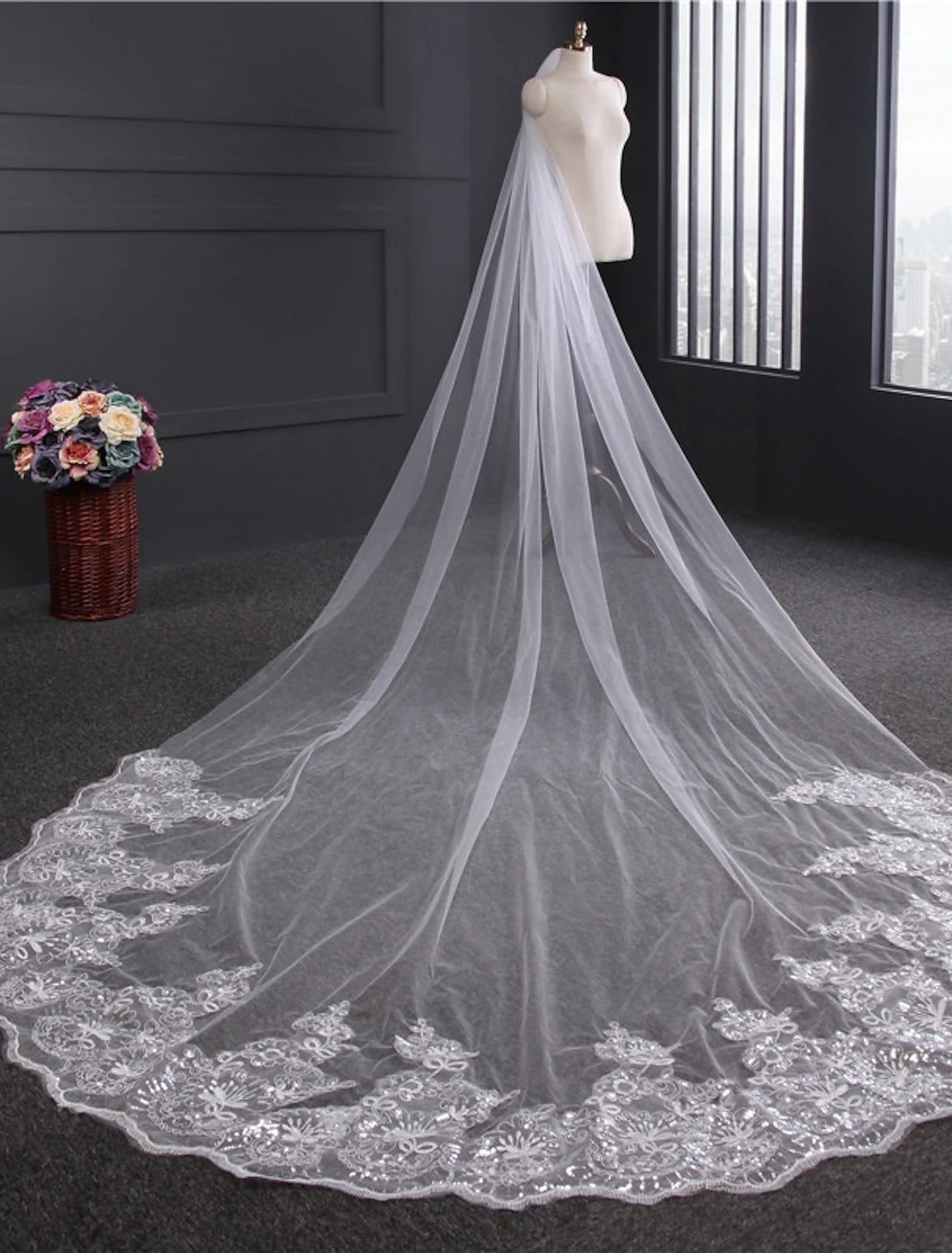 Close-up of the intricate lace and embroidery on a one-tier wedding veil.