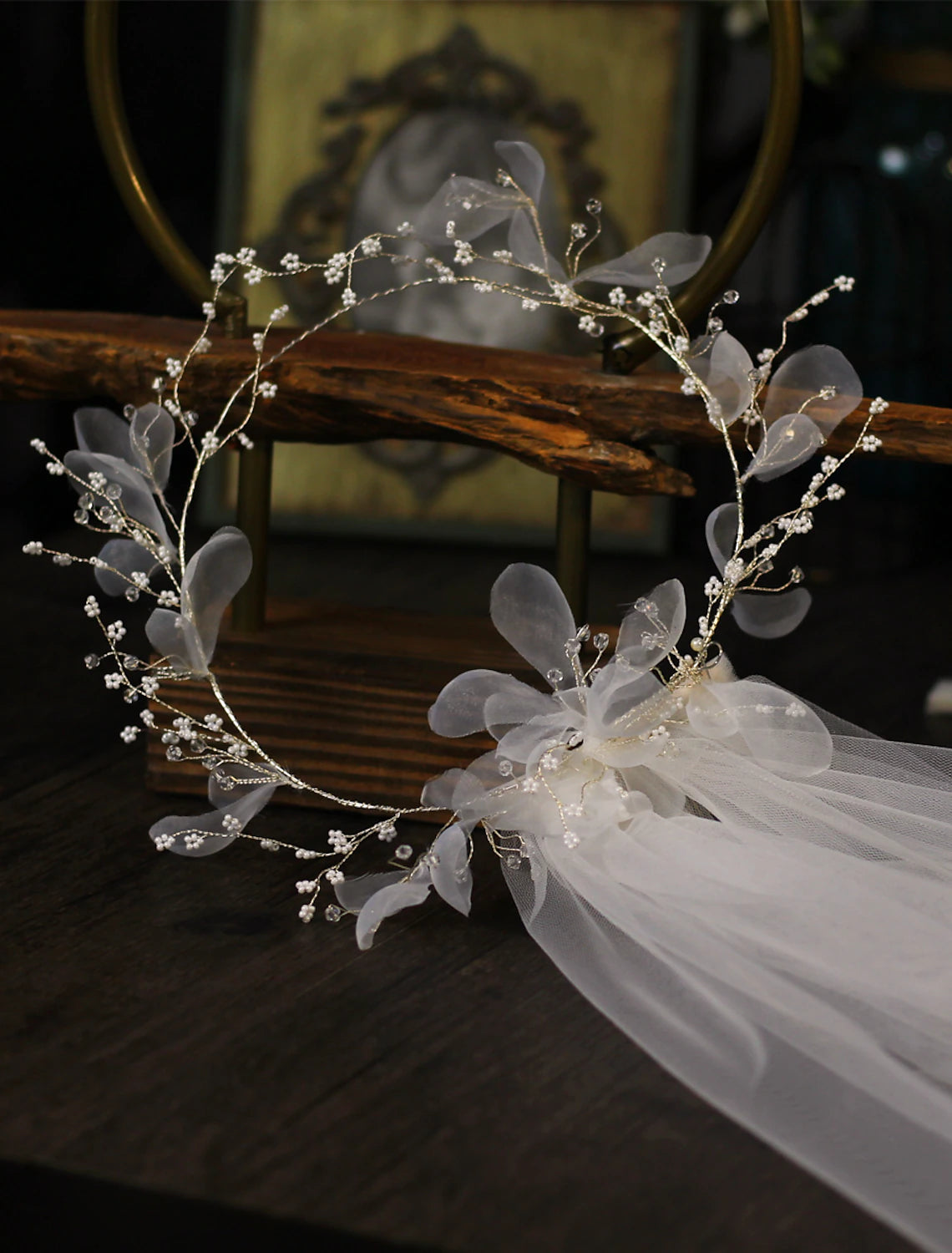 Elegant one-tier floral wedding veil with pendant on a bride.