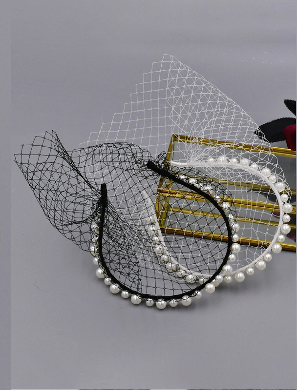 Model wearing a stylish one-tier pearl wedding veil in birdcage style.