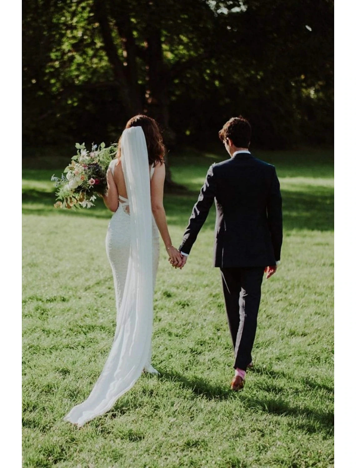 Back view of a bride with a simple cathedral wedding veil.